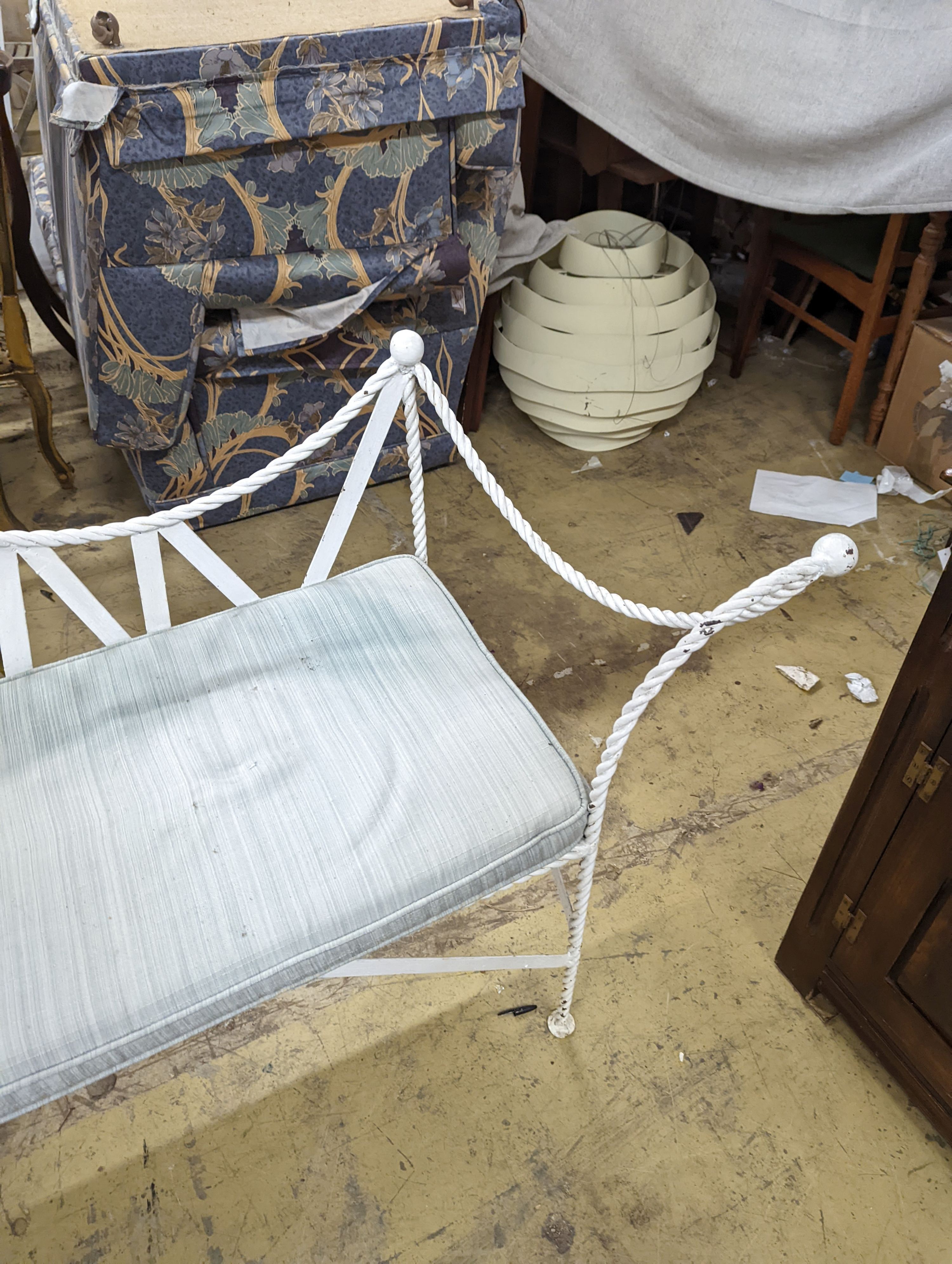 A wrought iron 'rope twist' seat with squab cushion, length 140cm, depth 54cm, height 132cm